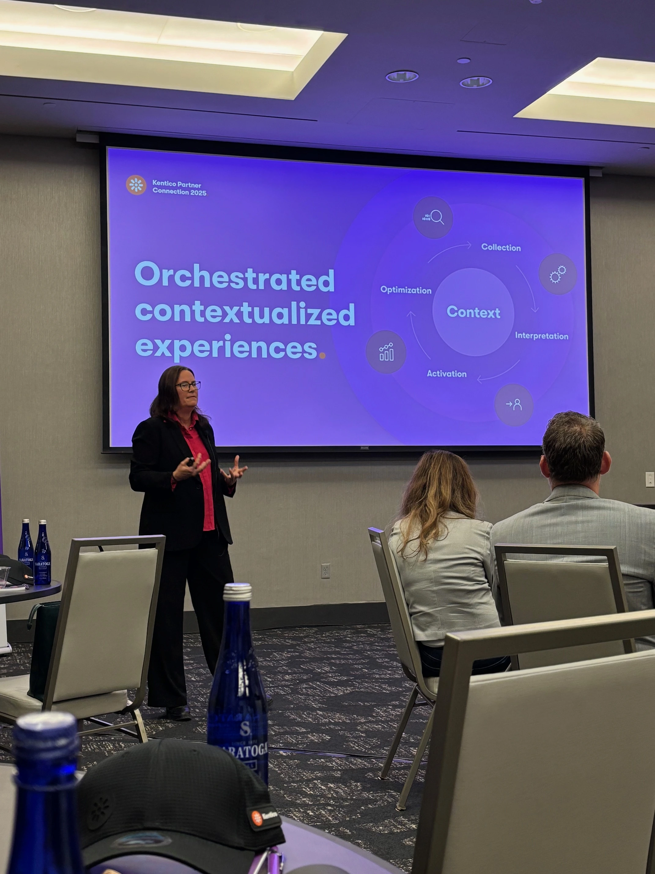xperience-by-kentico-contextualized-experiences-presentation.webp Speaker presents on orchestrated contextualized experiences at Xperience by Kentico event.